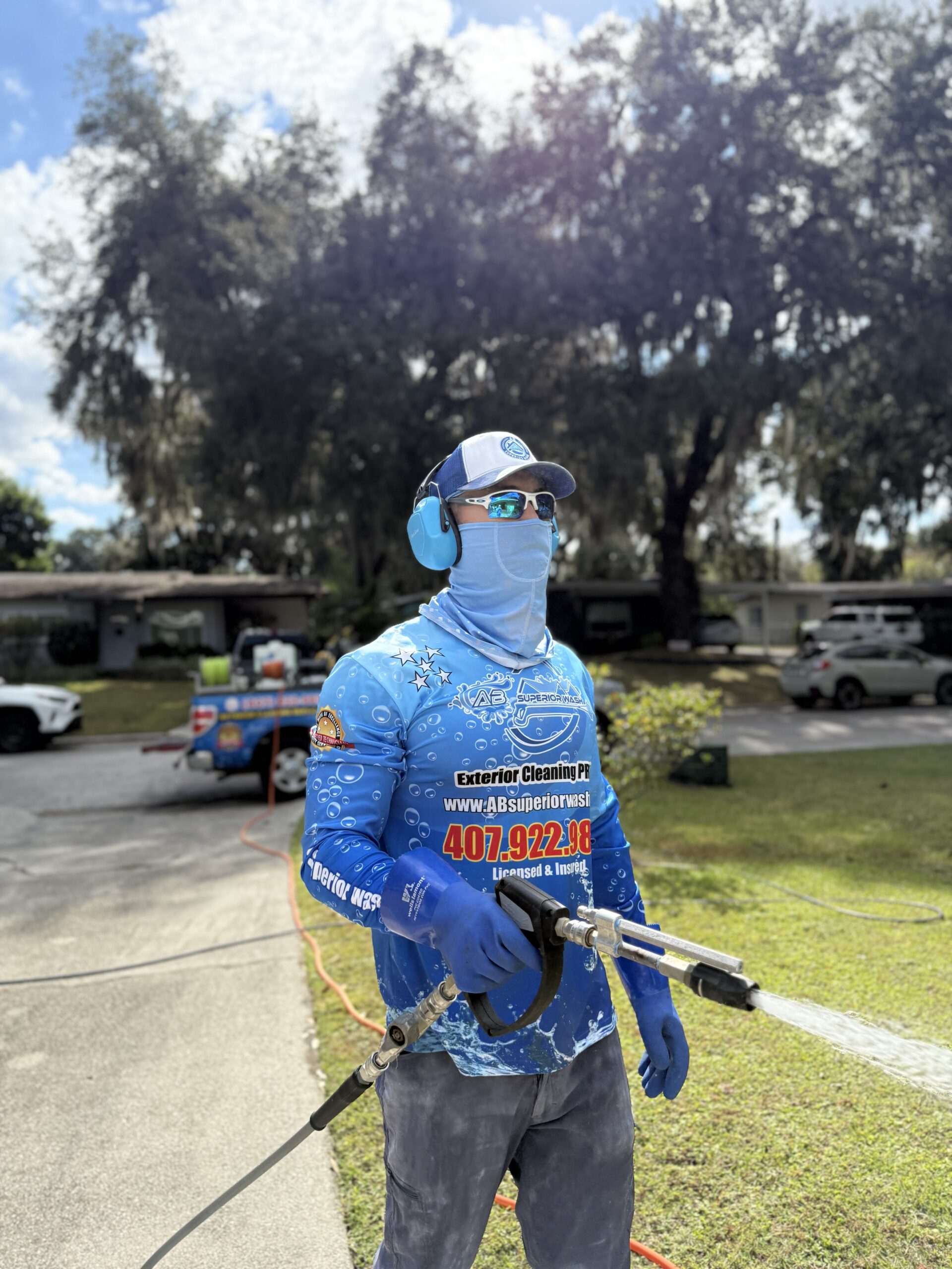 Alejandro, owner of AB Superior Wash, on a driveway job in the Orlando area — confirm this alt matches the actual photo
